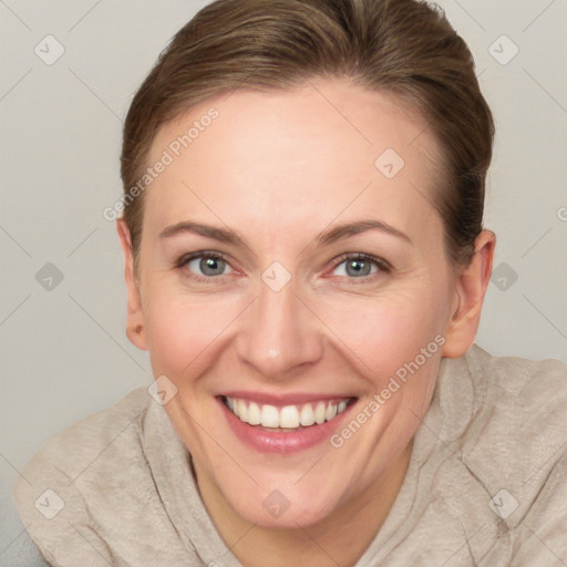 Joyful white adult female with short  brown hair and blue eyes