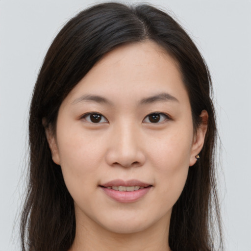 Joyful asian young-adult female with long  brown hair and brown eyes