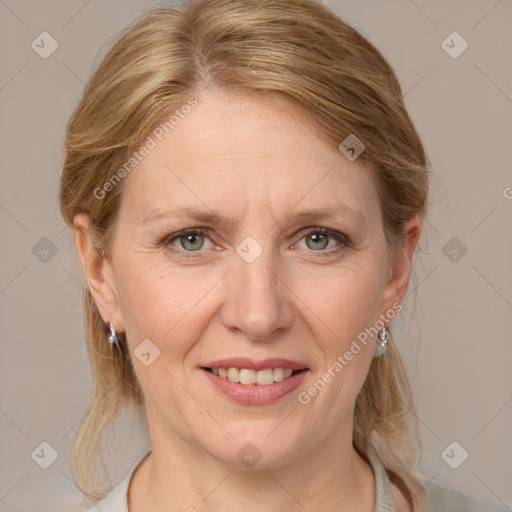 Joyful white adult female with medium  brown hair and blue eyes