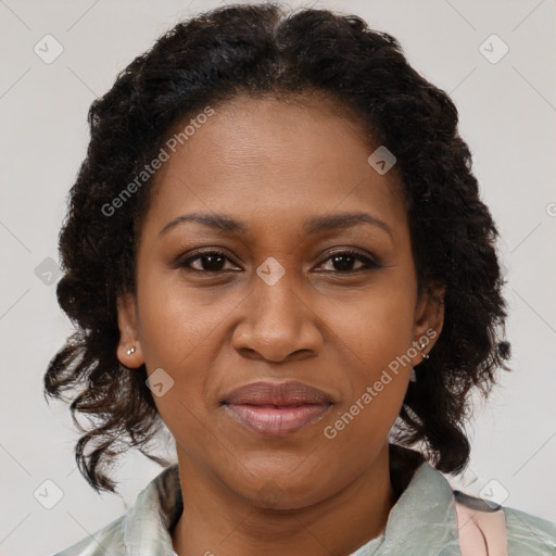 Joyful black adult female with medium  brown hair and brown eyes