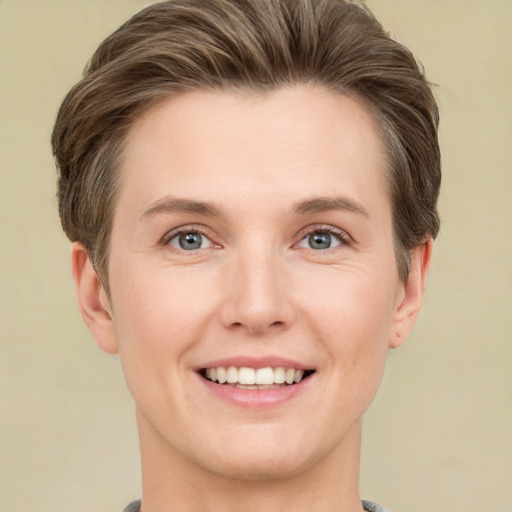 Joyful white young-adult female with short  brown hair and grey eyes