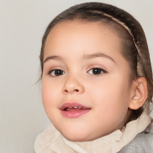 Joyful white child female with short  brown hair and brown eyes