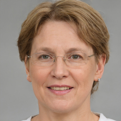 Joyful white middle-aged female with medium  brown hair and green eyes