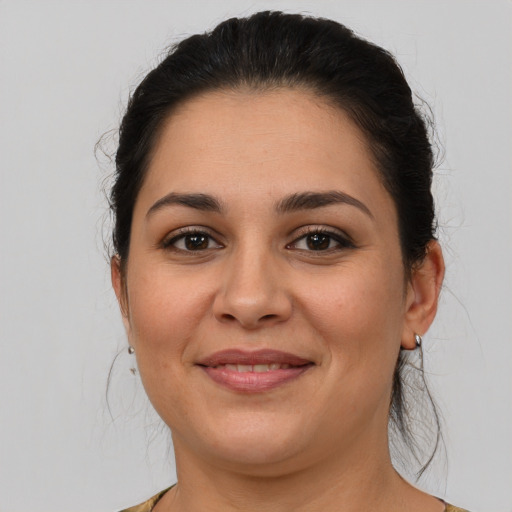 Joyful latino young-adult female with medium  brown hair and brown eyes