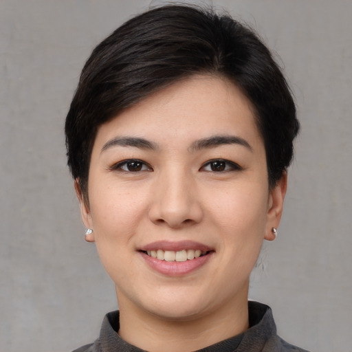 Joyful white young-adult female with short  black hair and brown eyes
