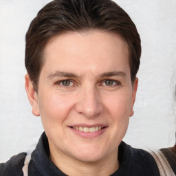 Joyful white adult male with short  brown hair and grey eyes