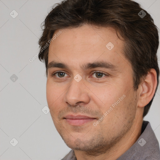 Joyful white adult male with short  brown hair and brown eyes