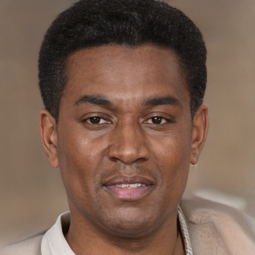 Joyful black young-adult male with short  brown hair and brown eyes