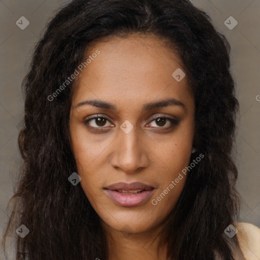 Joyful black young-adult female with long  brown hair and brown eyes