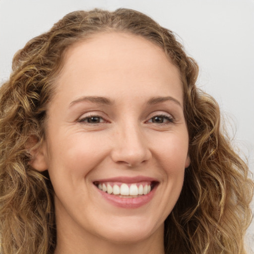 Joyful white young-adult female with long  brown hair and green eyes