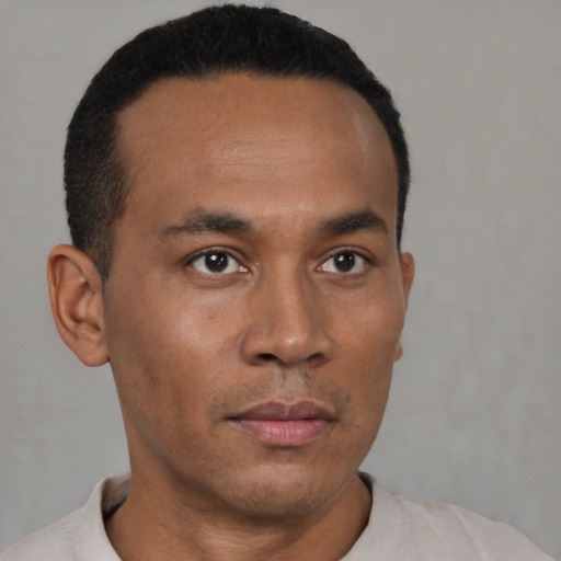 Neutral latino young-adult male with short  black hair and brown eyes