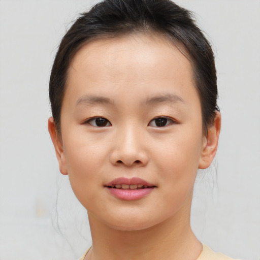 Joyful asian child female with short  brown hair and brown eyes