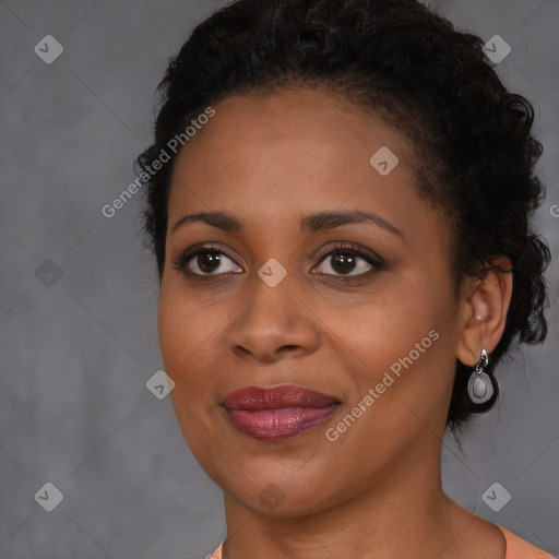 Joyful black young-adult female with long  brown hair and brown eyes