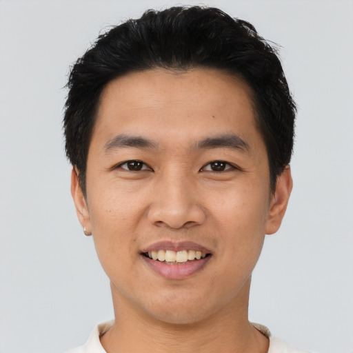 Joyful asian young-adult male with short  black hair and brown eyes