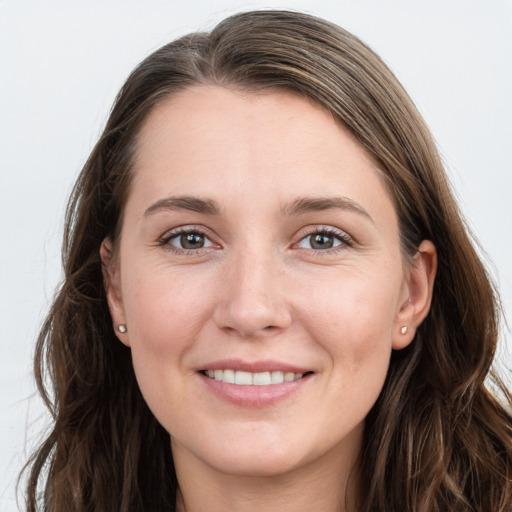 Joyful white young-adult female with long  brown hair and grey eyes