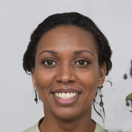 Joyful black young-adult female with medium  brown hair and brown eyes