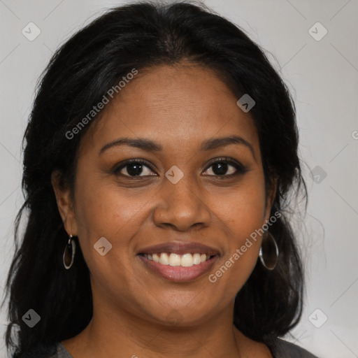 Joyful black young-adult female with long  brown hair and brown eyes