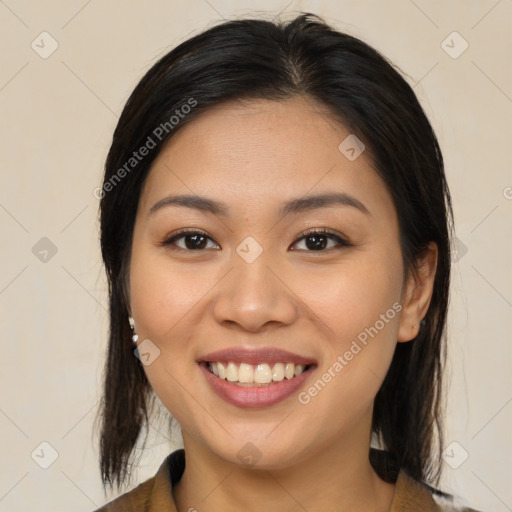 Joyful latino young-adult female with medium  brown hair and brown eyes