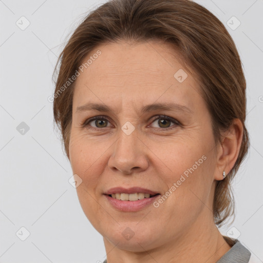 Joyful white adult female with medium  brown hair and brown eyes