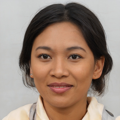 Joyful asian young-adult female with medium  brown hair and brown eyes