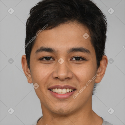 Joyful asian young-adult male with short  brown hair and brown eyes