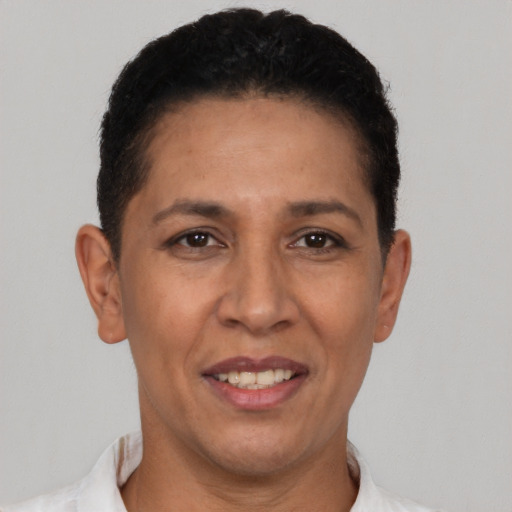 Joyful latino adult female with short  brown hair and brown eyes