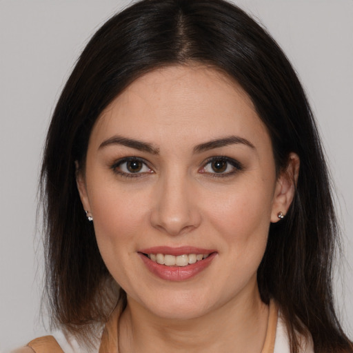 Joyful white young-adult female with medium  brown hair and brown eyes