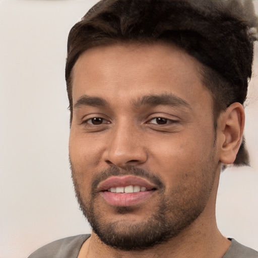 Joyful white young-adult male with short  black hair and brown eyes