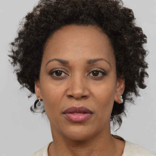 Joyful black adult female with short  brown hair and brown eyes