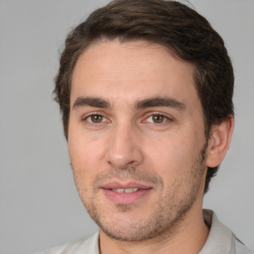 Joyful white adult male with short  brown hair and brown eyes