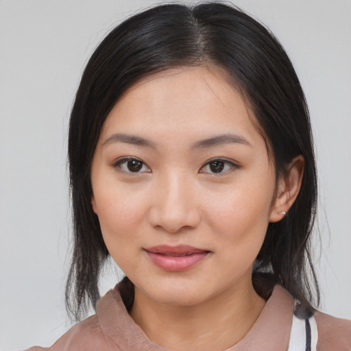 Joyful white young-adult female with medium  black hair and brown eyes