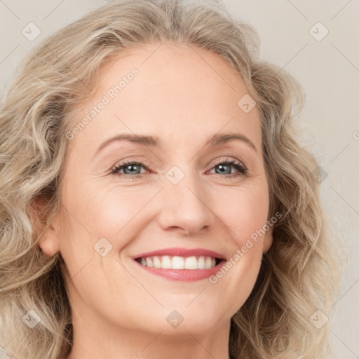 Joyful white young-adult female with long  brown hair and blue eyes