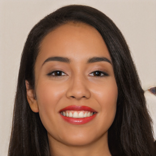 Joyful latino young-adult female with long  black hair and brown eyes