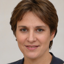 Joyful white adult female with medium  brown hair and grey eyes