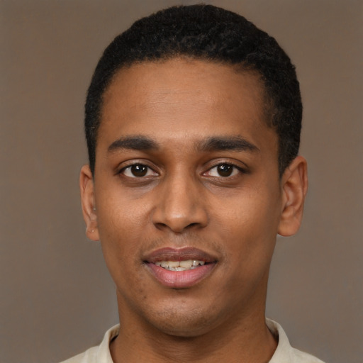 Joyful black young-adult male with short  black hair and brown eyes