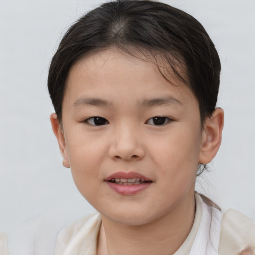 Joyful asian child female with short  brown hair and brown eyes