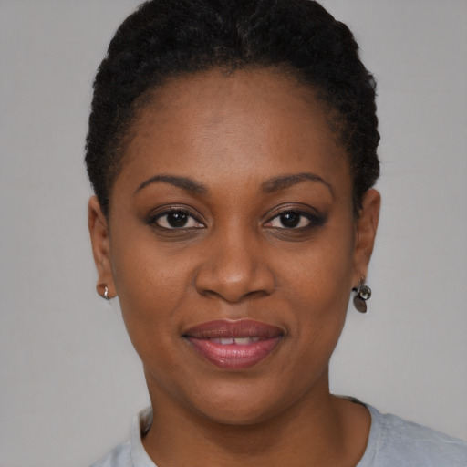 Joyful black young-adult female with short  brown hair and brown eyes