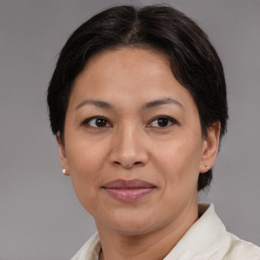 Joyful asian adult female with medium  brown hair and brown eyes