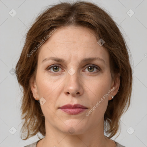 Joyful white adult female with medium  brown hair and grey eyes