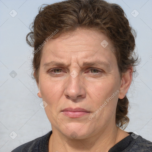 Joyful white adult female with medium  brown hair and blue eyes