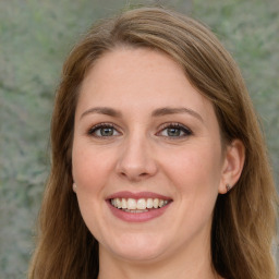 Joyful white young-adult female with long  brown hair and green eyes