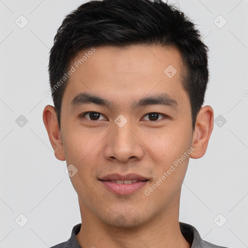 Joyful asian young-adult male with short  black hair and brown eyes