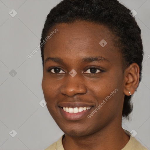 Joyful black young-adult female with short  black hair and brown eyes