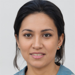 Joyful latino young-adult female with medium  brown hair and brown eyes