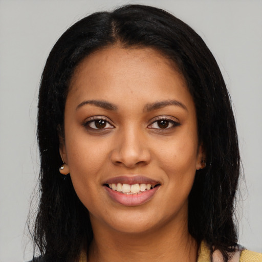 Joyful latino young-adult female with long  black hair and brown eyes