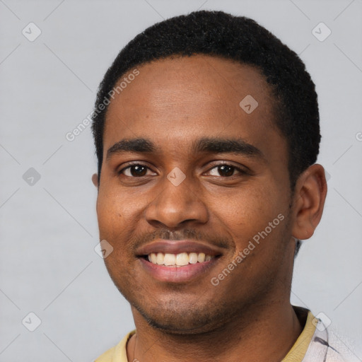 Joyful black young-adult male with short  black hair and brown eyes