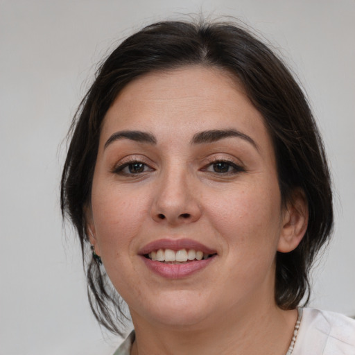 Joyful white young-adult female with medium  brown hair and brown eyes