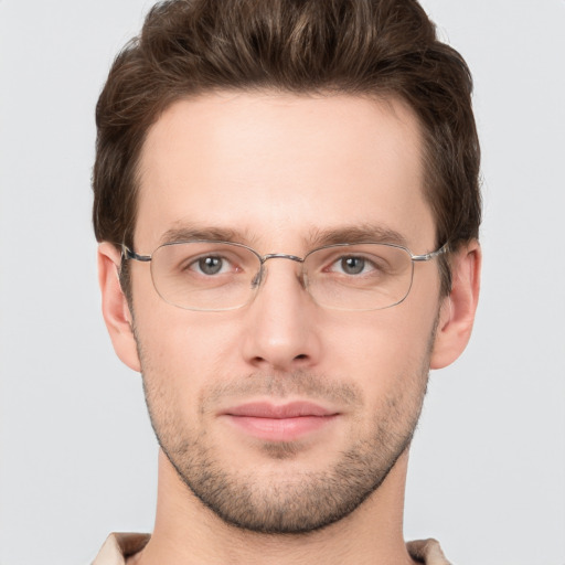 Joyful white young-adult male with short  brown hair and grey eyes