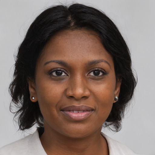 Joyful black young-adult female with medium  brown hair and brown eyes