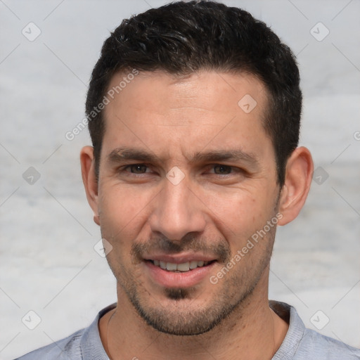 Joyful white adult male with short  brown hair and brown eyes